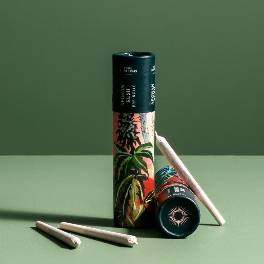 Two small Afghan Kush tubes with three pre-rolls scattered around.