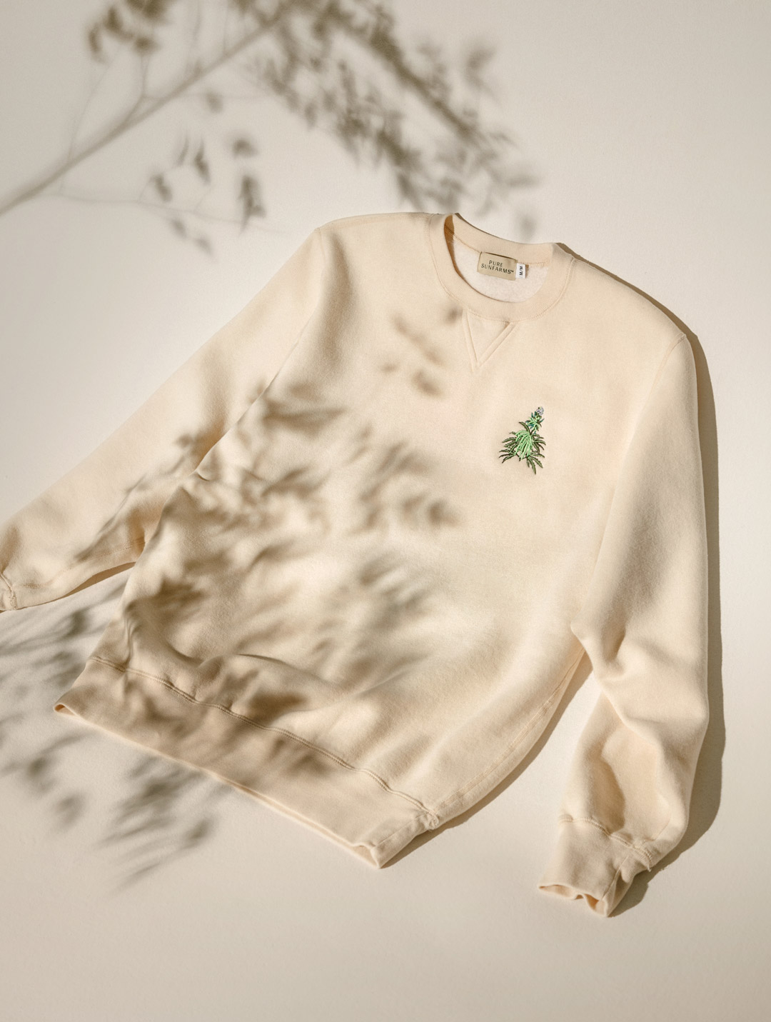 beige crewneck with cannabis plant embroidery 