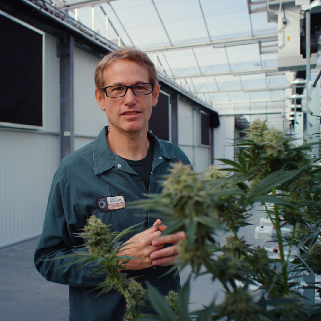  head grower, Rob Baldwin, in greenhouse.