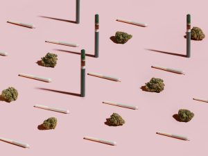Pink Kush buds, pre-rolls, and vapes on pink background