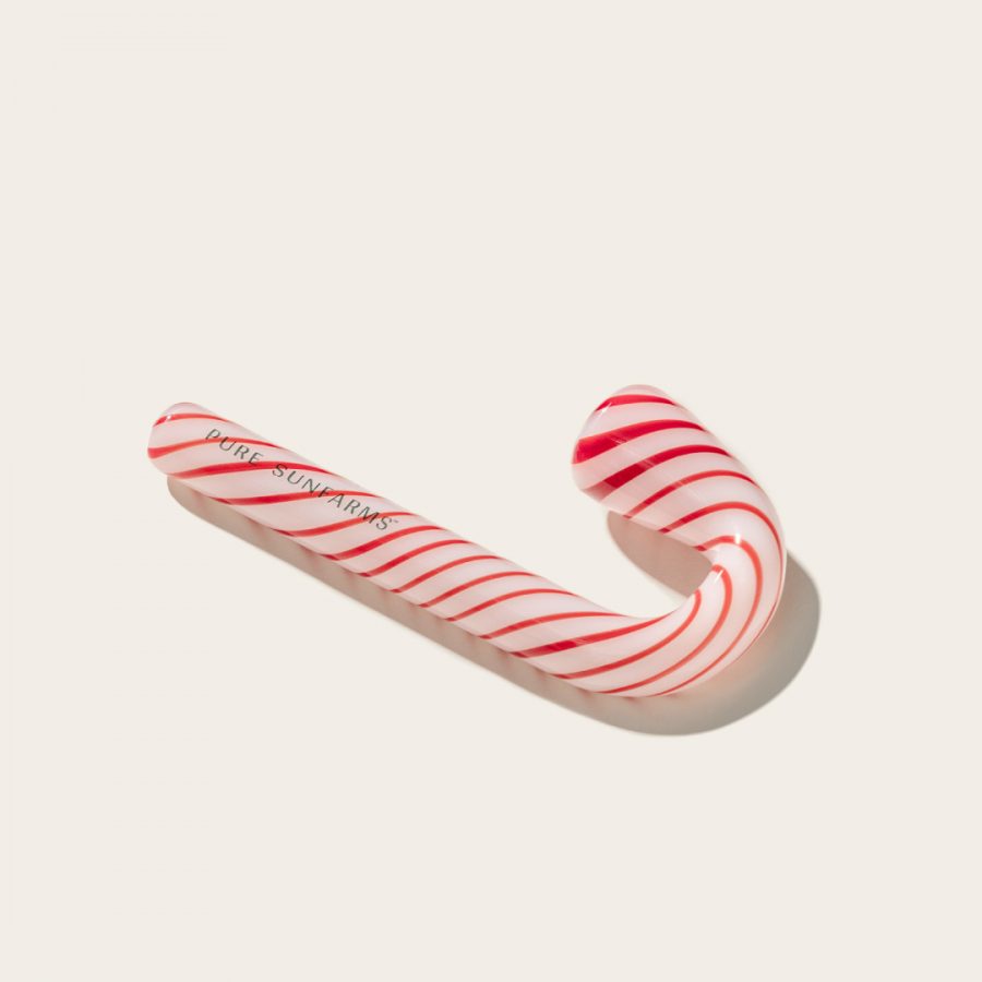 Candy cane pipe on cream background