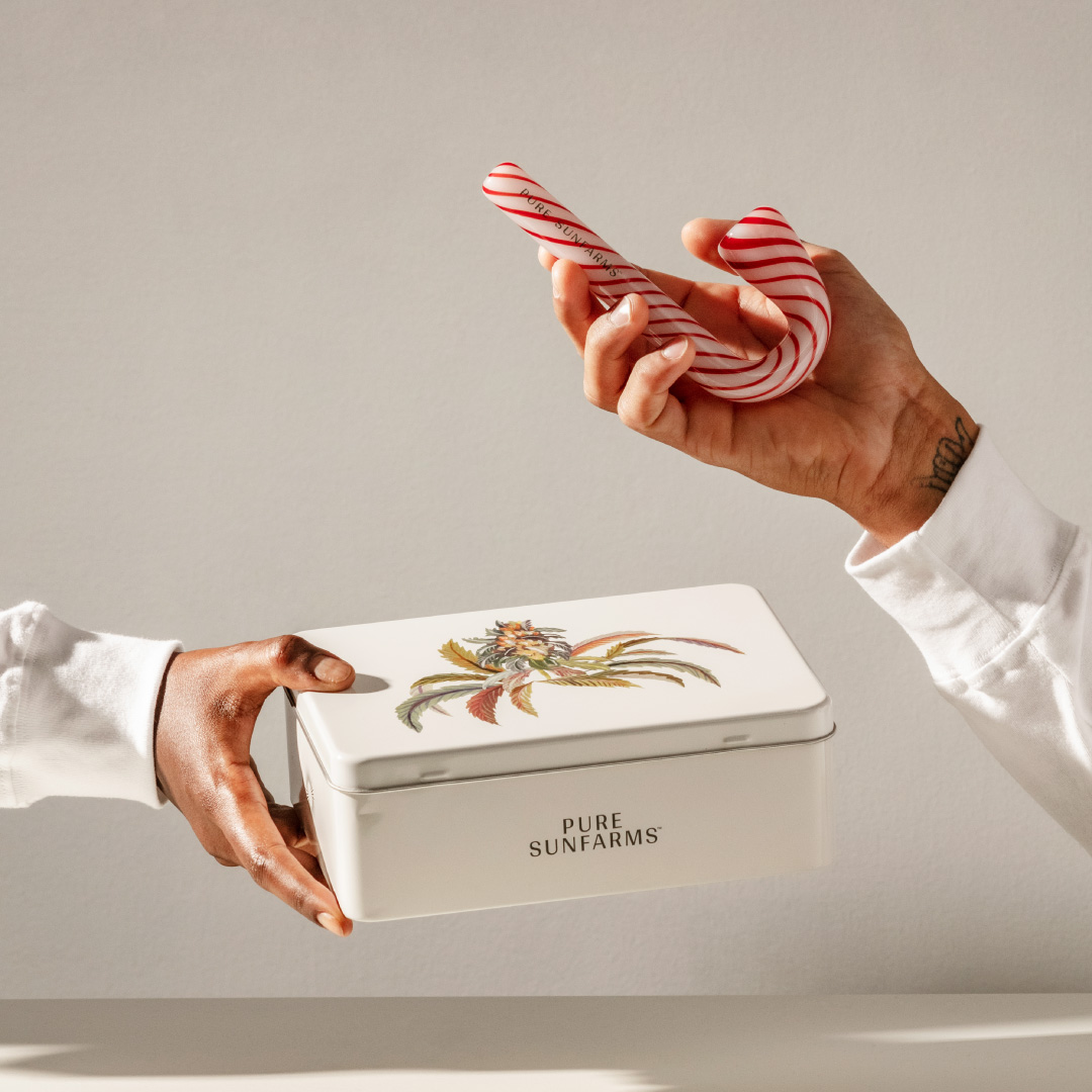 Model holding Candy Cane Pipe and Stash Tin