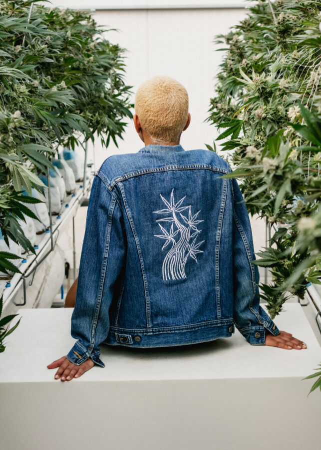 Model wearing jean jacket in the greenhouse