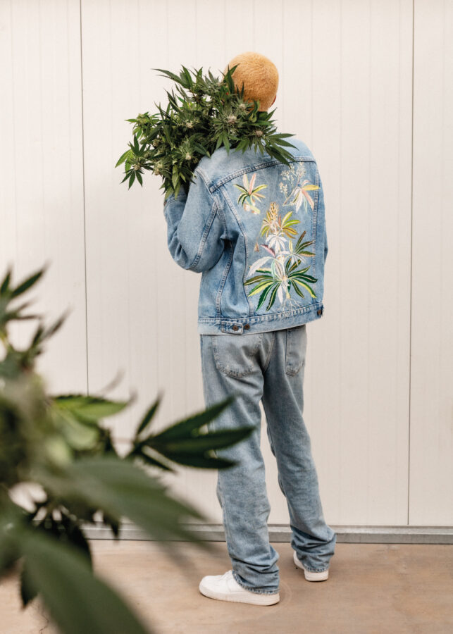 Model wearing Flowerhood garment in the greenhouse
