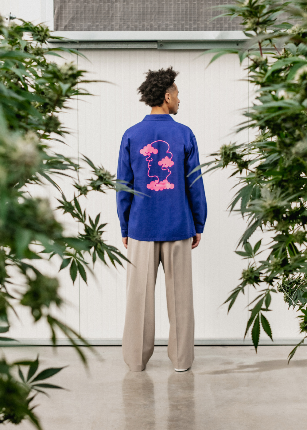 Model wearing Flowerhood garment in greenhouse